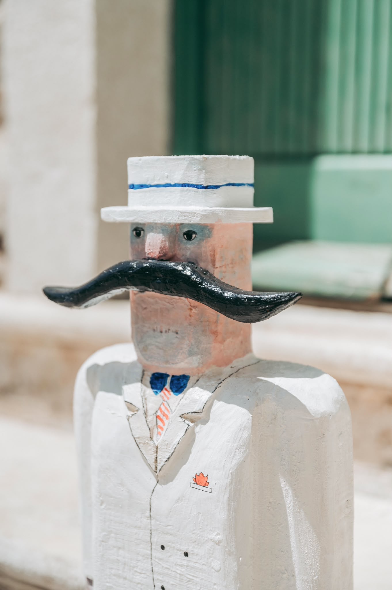 Close-up of a white handmade horse sculpture with painted and found-object details